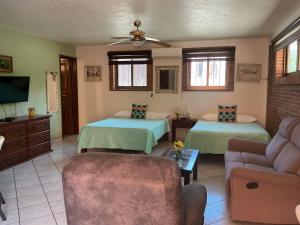a living room with two beds and a couch at Brisa Suave Studio Suite in Punta Mita
