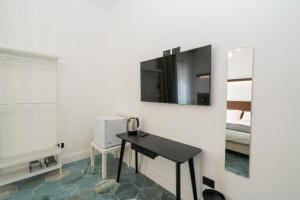 a room with a table and a mirror and a bed at Ca'santoro 3 in Agerola