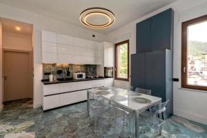 a kitchen with a table and a counter top at Ca'santoro 3 in Agerola