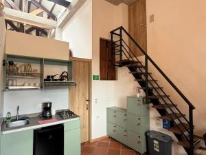 a kitchen with a spiral staircase in a room at Hostal Boutique Loto de Belén in Bogotá
