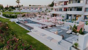 an aerial view of a resort with a pool and lounge chairs at The Palms Concept Hotel Adults Only 16 Plus in Faliraki