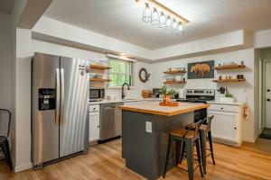 a kitchen with a stainless steel refrigerator and wooden floors at Peace at Last by Railey Vacations in McHenry
