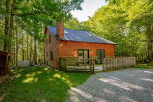 a small cabin in the woods with a fence at Peace at Last by Railey Vacations in McHenry
