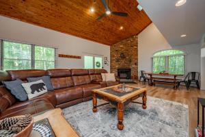 a living room with a brown leather couch and a table at Peace at Last by Railey Vacations in McHenry +36 photos