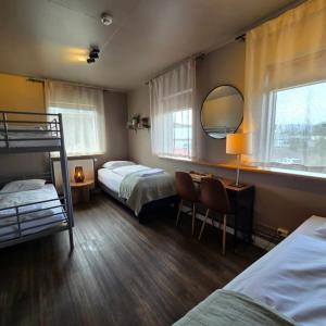 a bedroom with two bunk beds and a mirror at Akureyri Hostel in Akureyri