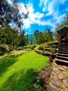 a garden with stairs leading up to a house at Springdale Villa in Kodaikānāl