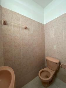 a bathroom with a toilet and a sink at Habitación 11 Posada Itzel in Oaxaca City