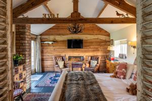 a room with a large bed and a living room at 8lacksmith's Shop in York