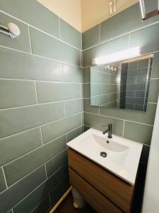 a bathroom with a sink and a mirror at Studio Cosy - Le Grand-Bornand in Le Grand-Bornand