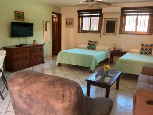 a living room with two beds and a couch at Brisa Suave Studio Suite in Punta Mita +30 photos