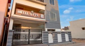 a hotel with a sign on the front of it at hotel 0771 in Raipur