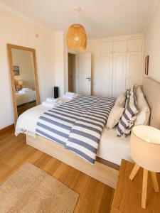 a bedroom with a large bed and a mirror at Atlantic Ocean View Apartment in Funchal +32 photos