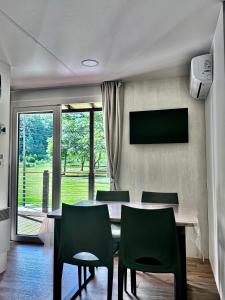 a dining room with a table and chairs and a television at Chalet - Snow Village Roccaraso in Roccaraso