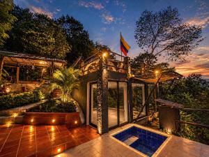 a house with a pool in the middle of a patio at Vega Glamping in La Vega