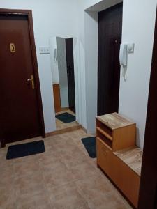 a bathroom with two doors and a tile floor at Smestaj Prokuplje in Prokuplje