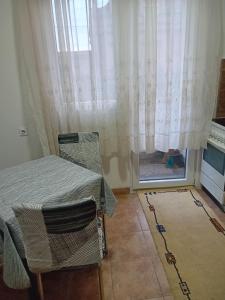 a room with a window and a table and chairs at Smestaj Prokuplje in Prokuplje