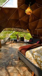 a bedroom with a bed in a tent at Vega Glamping in La Vega +43 photos