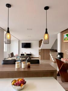 a living room with two pendant lights and a bowl of fruit at Departamento CENTRICO CENTRO LOJA in Loja +21 photos