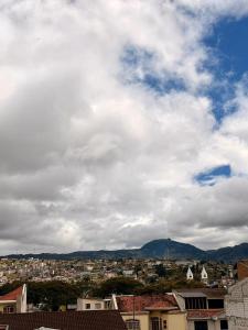 a view of a city under a cloudy sky at Departamento CENTRICO CENTRO LOJA in Loja