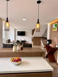 a living room with a bowl of fruit on a table at Departamento CENTRICO CENTRO LOJA in Loja