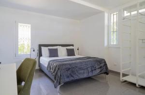 a white bedroom with a bed and a book shelf at Marghera Venice Link Rooms in Venice