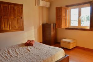 a bedroom with a bed with two slippers on it at Cantinho do Minho - Ponte de Lima in Ponte de Lima