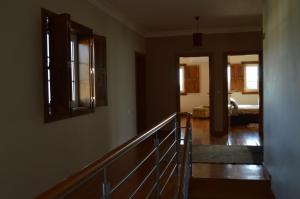 a hallway with a staircase and a living room at Cantinho do Minho - Ponte de Lima in Ponte de Lima