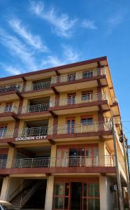 a tall building with balconies on the side of it at Home23 Apartments in Jinja
