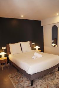a bedroom with a large bed with white sheets at Jolie T2, RDC, Proche du lac in Aix-les-Bains