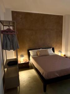 a bedroom with a large bed and a shelf at Nice Sea Suite in Salerno