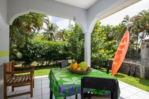 a table with a bowl of fruit on a patio at Bungalow Tearo in Tiripoa