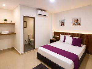 a bedroom with a large bed and a bathroom at Hotel Gama Cartagena in Cartagena de Indias +29 photos