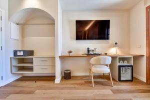 a kitchen with a table and a chair in a room at Las Torres by Santas Hotels in Altea