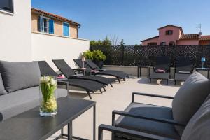 a row of chairs and tables on a patio at Villa9eleven in Novigrad Istria