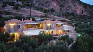 an aerial view of a house with a mountain at Riza Apartments in Kardamyli