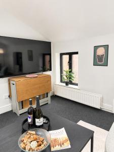a living room with a table with a bowl of food at Cosy Coach House - Belfast in Belfast