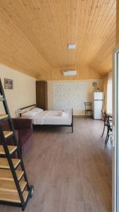 a large room with a bed and a wooden ceiling at KOTE.GE in Lagodekhi