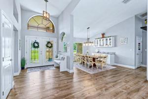 a living room with a table and a dining room at Paradise On Park in Seminole