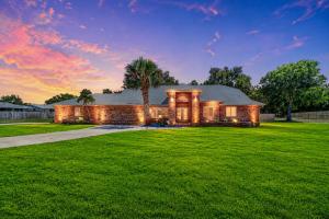 a house with a palm tree on a lawn at Paradise On Park in Seminole