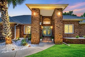 a brick house with a front door and a palm tree at Paradise On Park in Seminole