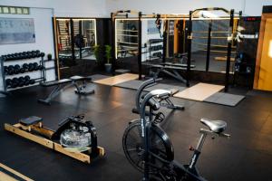 a gym with bikes and weights in a room at Wellness Glamping Apartmán Přerov in Přerov +48 photos