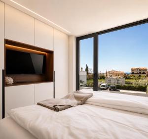 a bedroom with a large bed with a large window at Villa9eleven in Novigrad Istria +74 photos