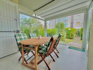 a wooden table and two chairs on a porch at Casa Lido in Lido Adriano