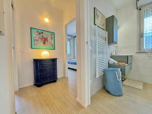 a living room with a fireplace and a bedroom at Casa Lido in Lido Adriano