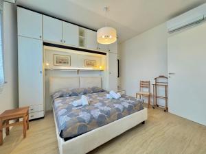 a bedroom with a bed and a table and a chair at Casa Lido in Lido Adriano