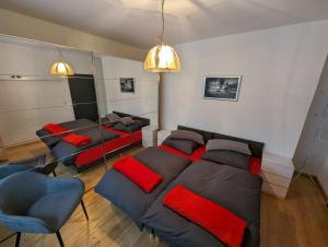 a bedroom with a bed and a couch and chairs at Ferienwohnung Mutter in Twiste