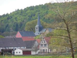 a group of buildings with a church with a steeple at Ferienwohnung Mutter in Twiste
