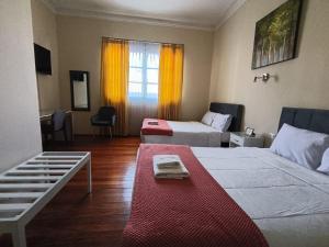 a hotel room with two beds and a window at Los Andes Bed & Breakfast in Arequipa