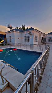 a swimming pool in front of a house at شاليه الجاكرندا 8 in Taif