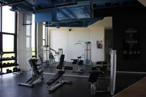 a gym with several treadmills and chairs in a room at Panoramic Lake View Cabo Norte Mérida in Mérida